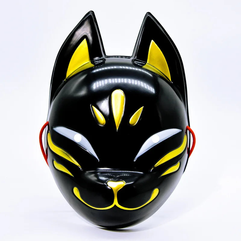 A glossy black fox face mask with yellow accents, shown from the front.