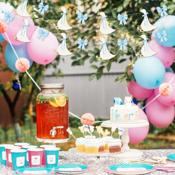 A banner featuring a Silly Goose with a bowknot garland strung across green foliage and pink balloons.
