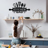 A woman in a white shirt is placing a metal kitchen sign on a wooden shelf above a sink area.