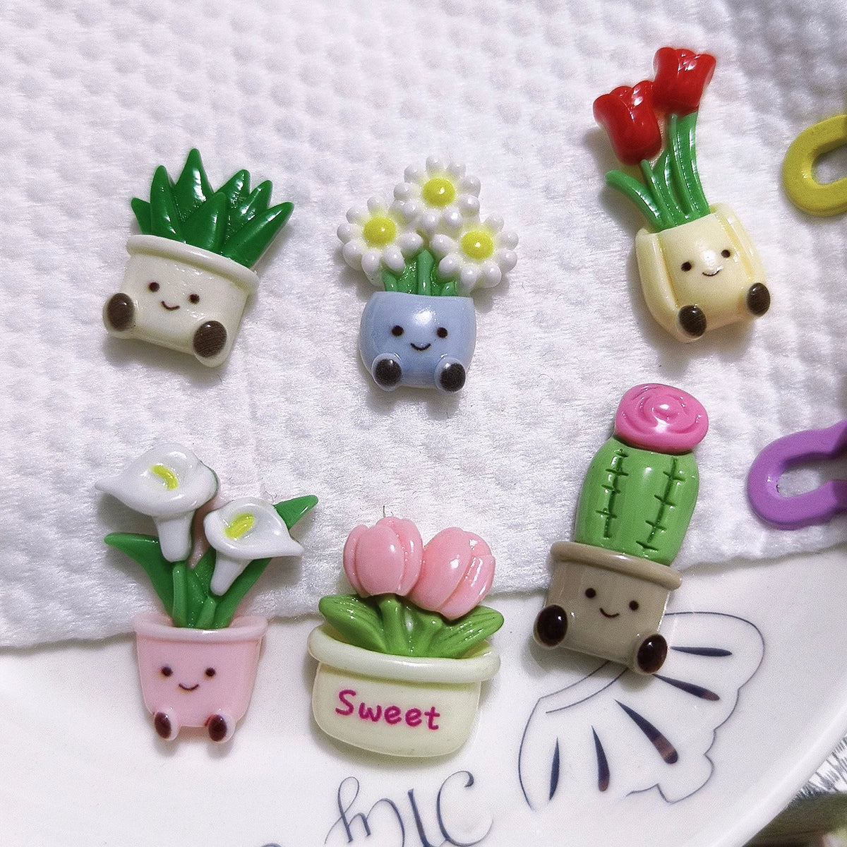A set of kawaii potted plant fridge magnets featuring various flowers and succulents in colorful pots.