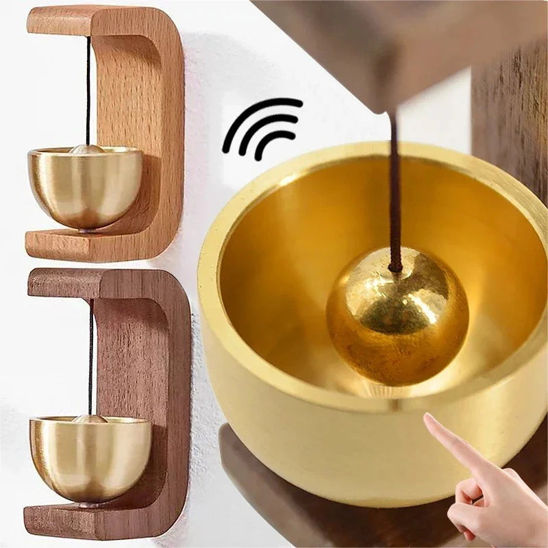 A magnetic wooden wind chime doorbell featuring a copper bell, shown in close-up against a white background.