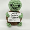 Handmade crochet turtle baseball bat doll with a positivity card