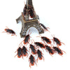 A collection of plastic cockroach gag toys, including a miniature Eiffel Tower design.