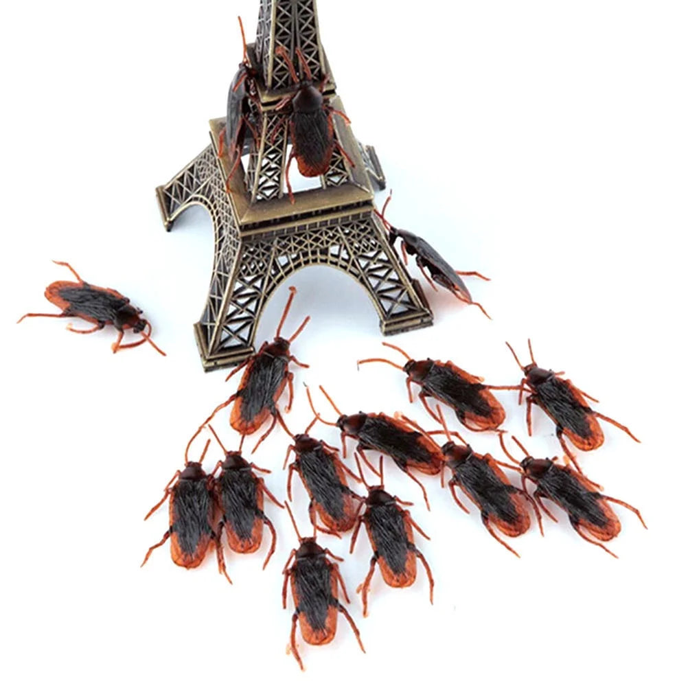 A collection of plastic cockroach gag toys, including a miniature Eiffel Tower design.