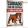Vintage metal sign featuring a bulldog illustration with Spanish text on a rustic iron background