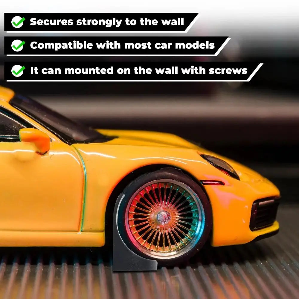 A yellow die-cast car model is mounted on a black display holder, showing its side view.