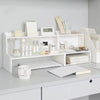 A white two-layer desktop organizer shelf displaying various stationery and desk supplies.