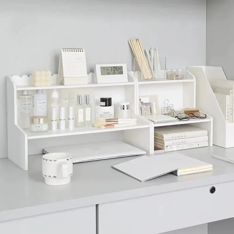 A white two-layer desktop organizer shelf displaying various stationery and desk supplies.