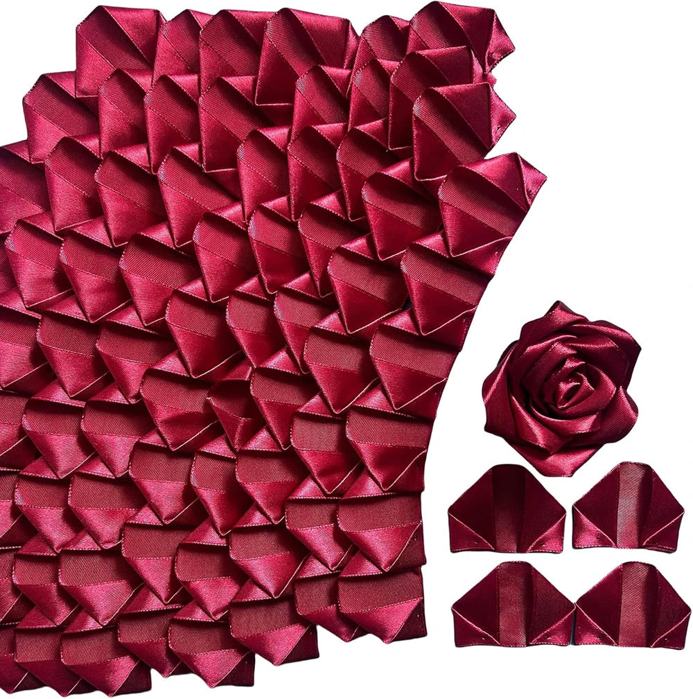 A dense arrangement of deep red satin ribbon rose petals for DIY flower bouquets.