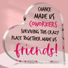 A heart-shaped plaque with pink text that reads Chance made us coworkers surviving this crazy place together made us friends