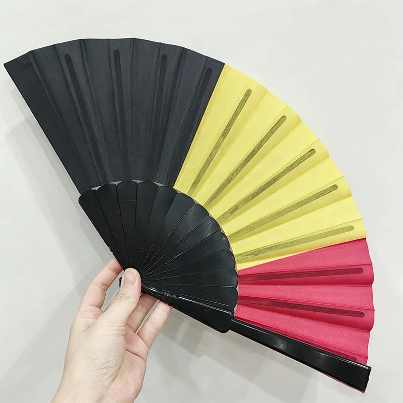A handheld folding fan featuring a design inspired by the country flag, shown partially opened.