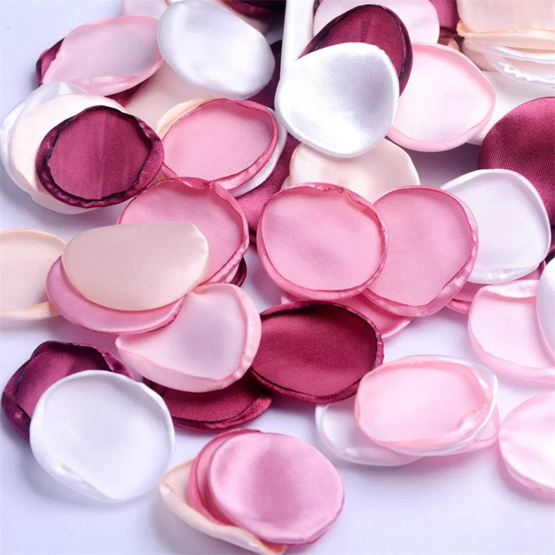 A collection of pink, mauve, and white silk rose petals for weddings and events.