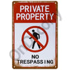 A vintage metal sign with a red background and white text warning against trespassing on private property.