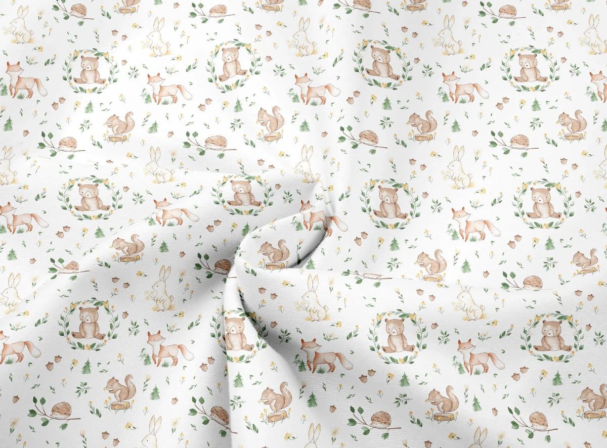 White fabric with a delicate floral print featuring small woodland animals like rabbits, squirrels, and birds.