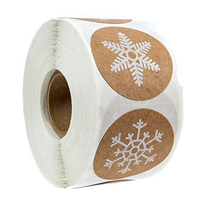 Roll of kraft paper thank you stickers with round labels featuring white snowflake designs