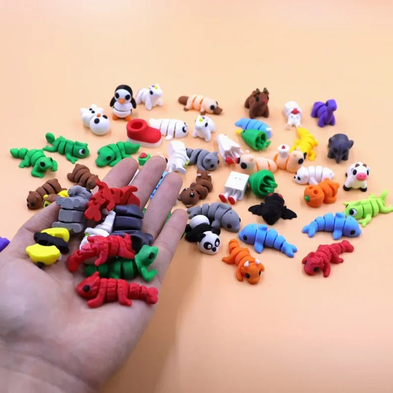 A hand holds a collection of colorful 3D printed cartoon animal figurines and toys on a light orange background.