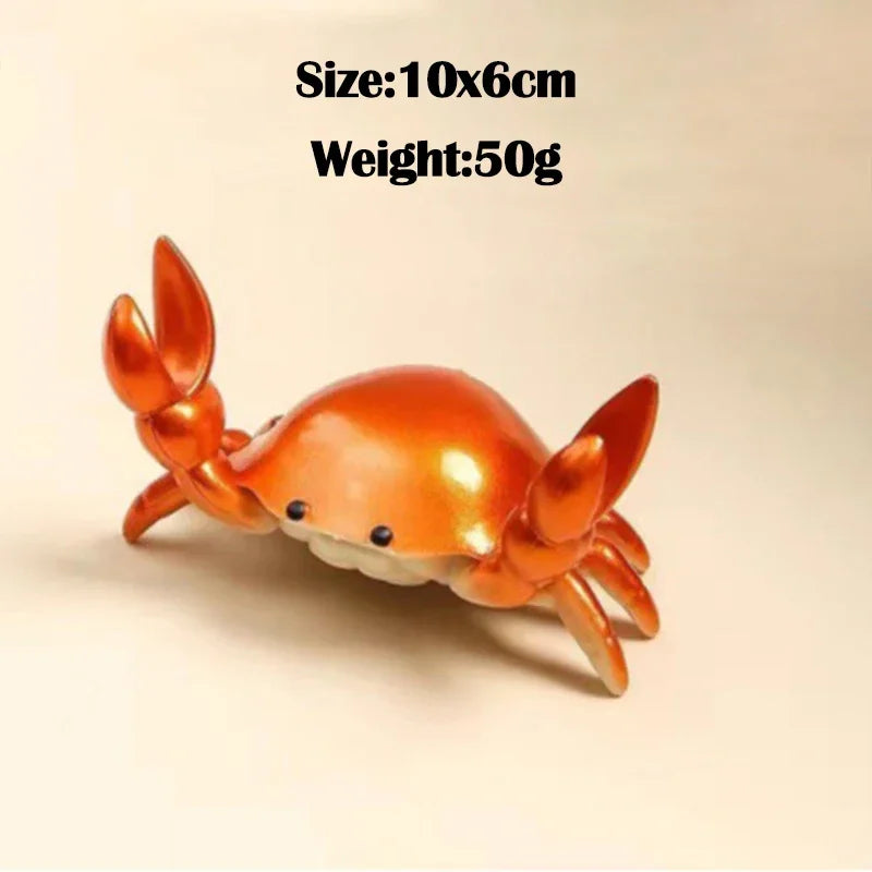 An orange crab-shaped desk organizer with slots for a pen and phone.