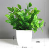 A vibrant green artificial bonsai plant with eucalyptus leaves in a white pot.