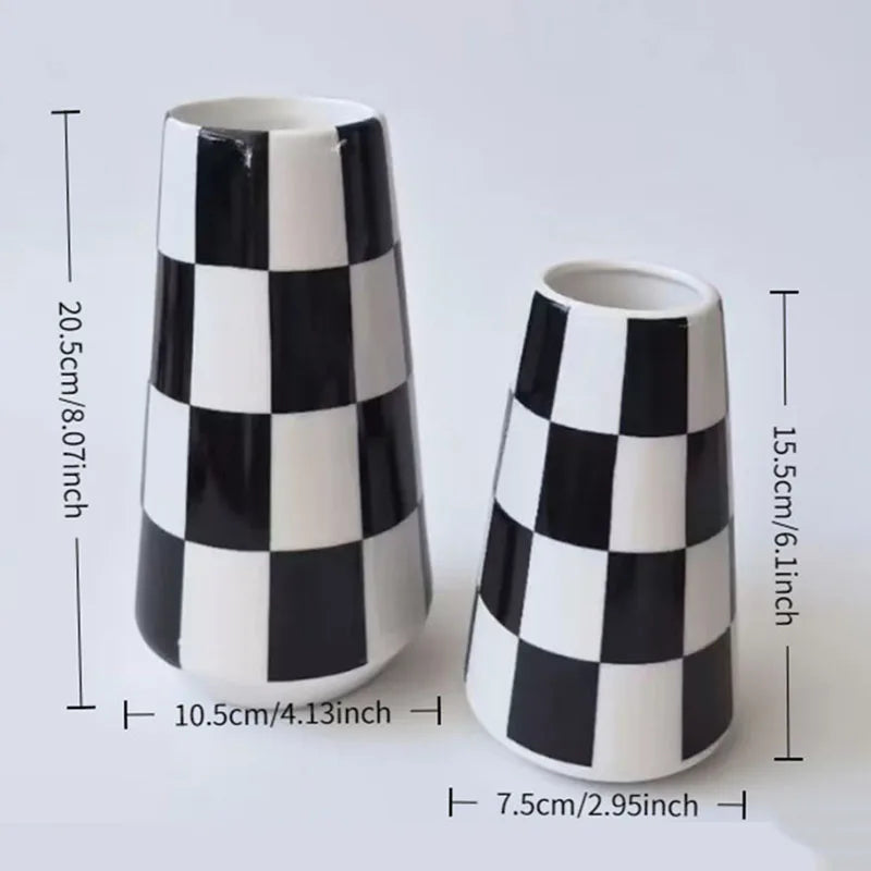 A tall ceramic tabletop vase with a black and white checkered pattern.