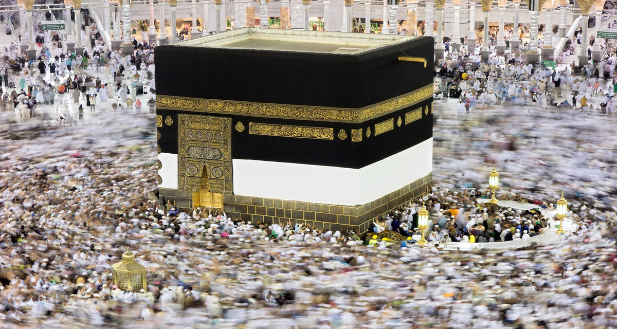 A canvas print depicting the Kaaba and Al Masjid An Nabawi, featuring black, gold, and white architectural elements.