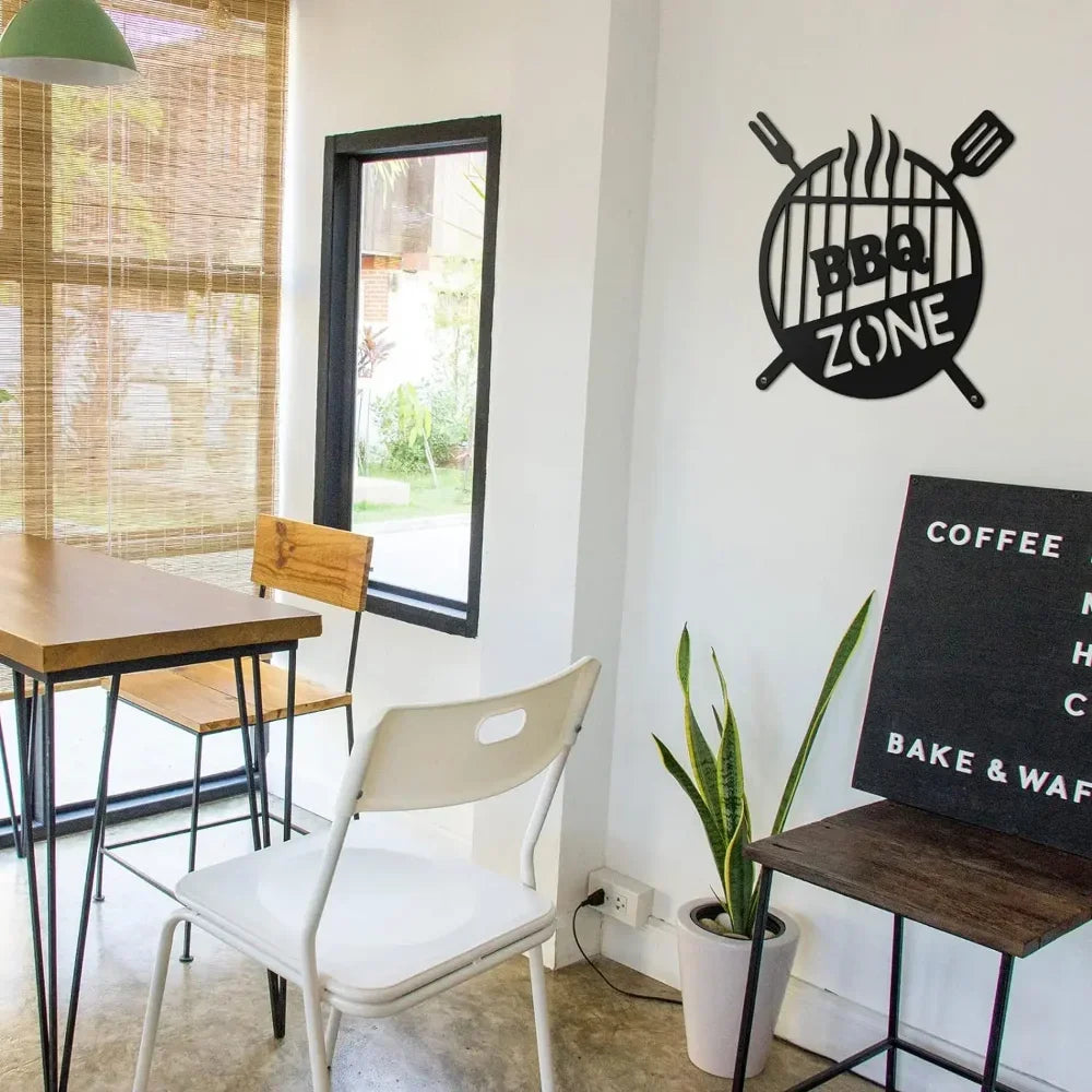 Black retro BBQ zone wall decor featuring a circular design with crossed utensils on a white wall.