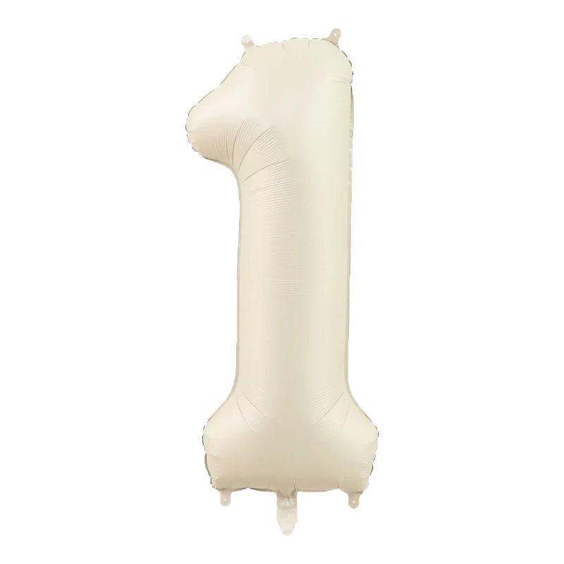 A large, beige foil number balloon shaped like the number 1.