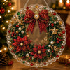 A round Christmas wreath made of red and green beads, pearls, and gold accents for a diamond painting craft.