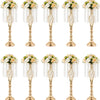 A set of gold crystal vases used for wedding centerpieces, featuring floral arrangements.