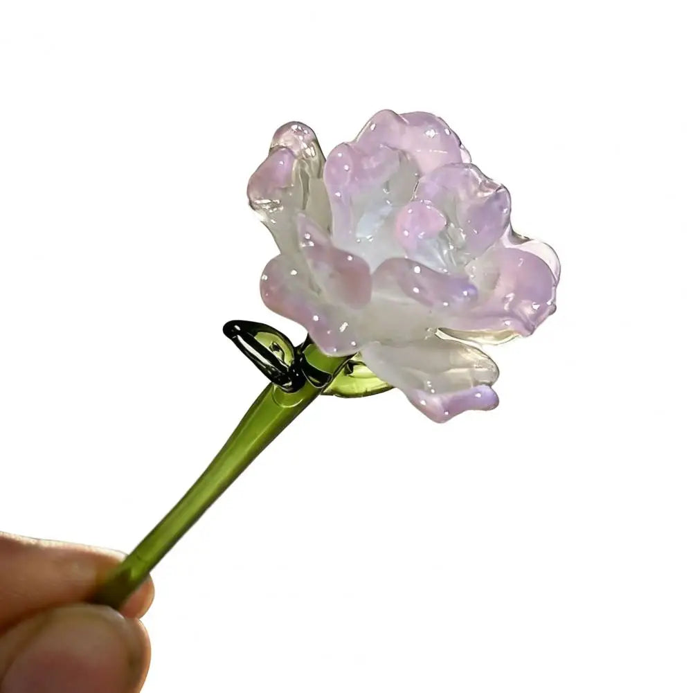 Handcrafted blue glass flower sculpture with a green stem and gold wire detail