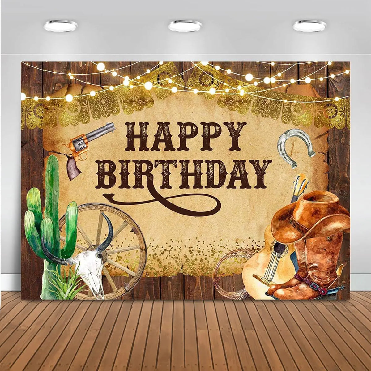 A rustic western backdrop featuring a barn door, cacti, a guitar, and an old revolver with string lights.