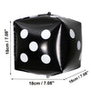 Black foil balloon shaped like a die with white polka dots, used for party decor.