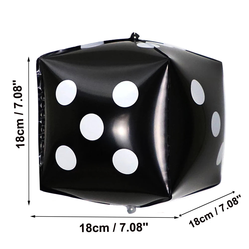 Black foil balloon shaped like a die with white polka dots, used for party decor.