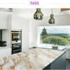 A kitchen countertop made of marble contact paper with pink and beige veining, featuring modern cabinetry and a large window 