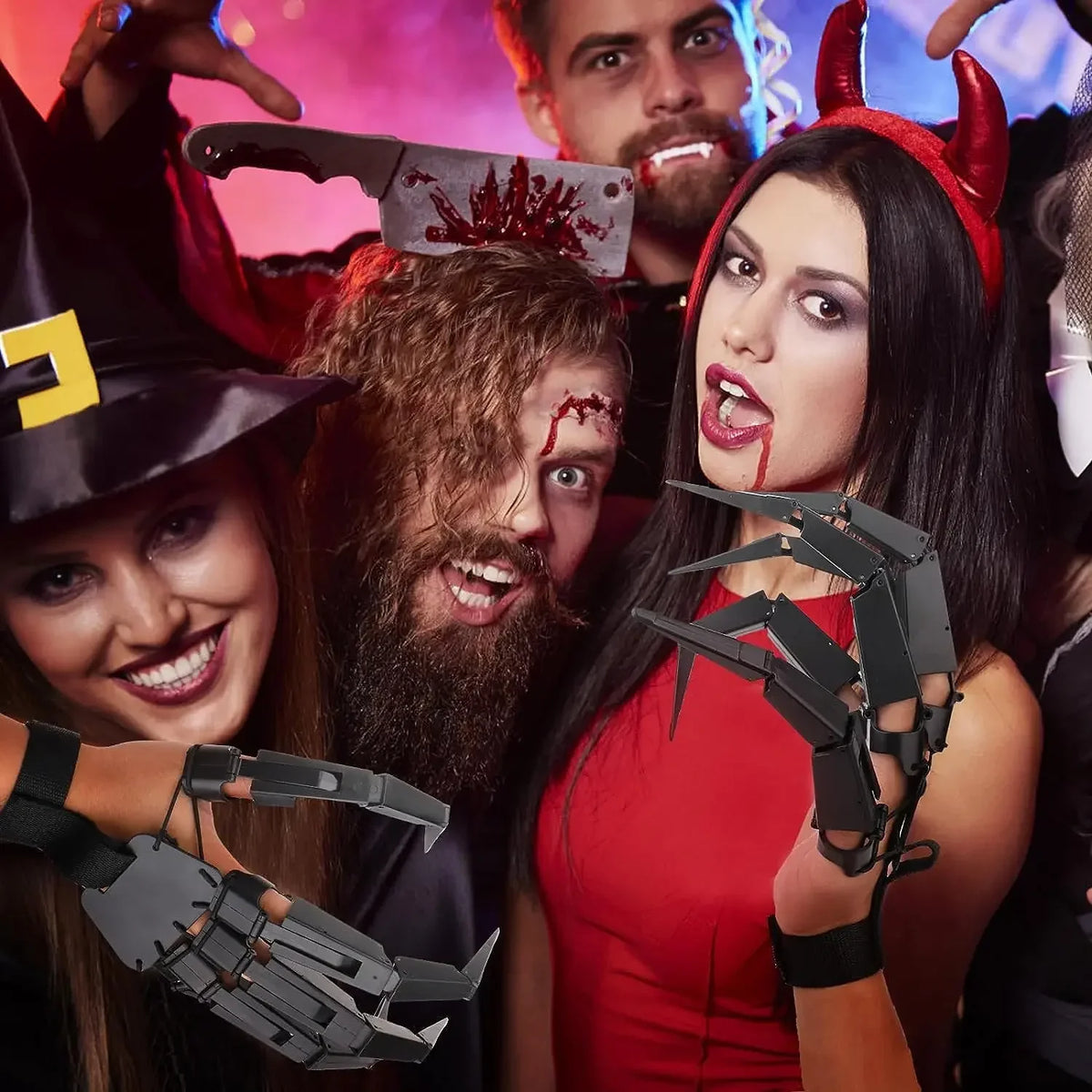 A woman wearing black skeleton hand gloves smiles while posing with a man and a witch hat in a Halloween-themed photo.