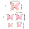 Three butterfly cake toppers in pink and gold, varying in size.