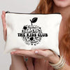 A cream-colored canvas makeup bag featuring a black silhouette of a leaf and the text THE KIDS CLUB
