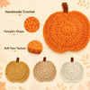 Handmade crochet pumpkin coasters in orange, beige, and gray yarn textures.