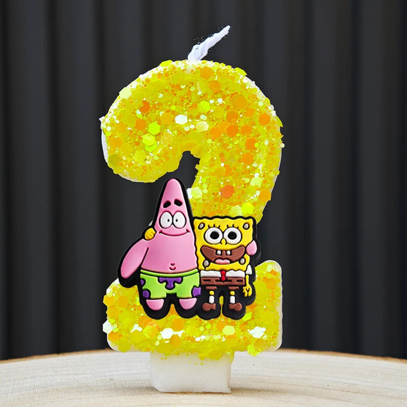 A yellow sponge cake shaped like the number 2, decorated with SpongeBob SquarePants characters.