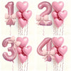 A set of pink heart-shaped number balloons 1, 2, 3, and 4 with bows and streamers for party decoration.