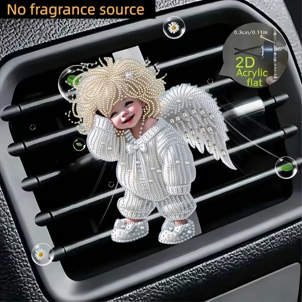 A cute white acrylic teddy bear with gold accents is clipped onto a car vent for decoration.