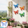 Set of four vibrant metal butterfly wall art decorations displayed on a light-colored stucco wall.