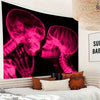 Gothic pink skull x-ray tapestry featuring two skulls in a dark romantic style on a wall.