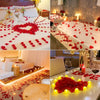 Red silk rose petals scattered on white fabric and surfaces for weddings and events