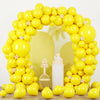A bright yellow archway made of latex balloons for parties and celebrations