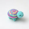 Handmade crocheted turtle plush with colorful patterned shell and blue head