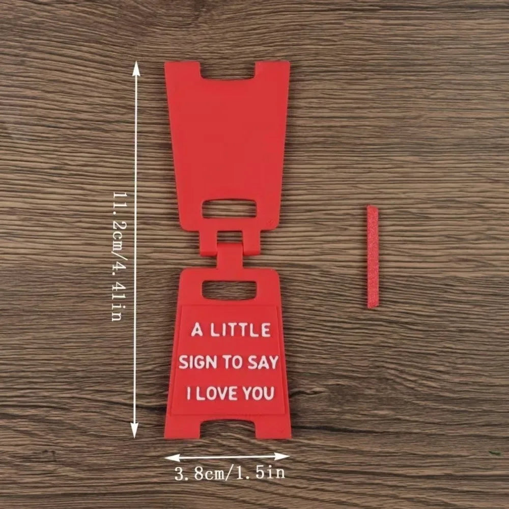 A red 3D printed letter sign ornament shaped like a hanger with the text I love you on it.