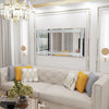 A silver crystal rhinestone wall mirror with a sparkling frame displayed in a bright, elegant room.
