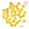 A pile of 50 gold pirate coin party favors, measuring 2.5cm and weighing 0.6g.