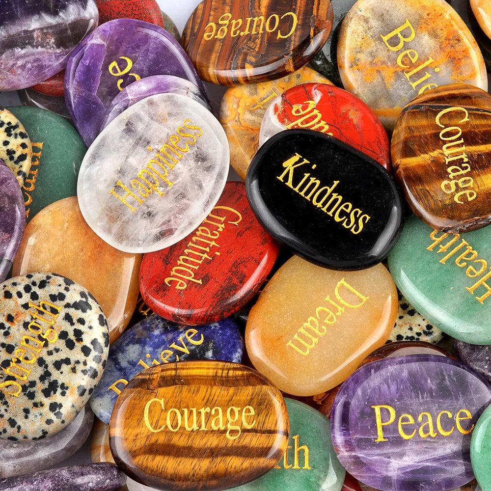 A collection of polished natural crystal ellipses in various colors including purple, orange, green, and black.