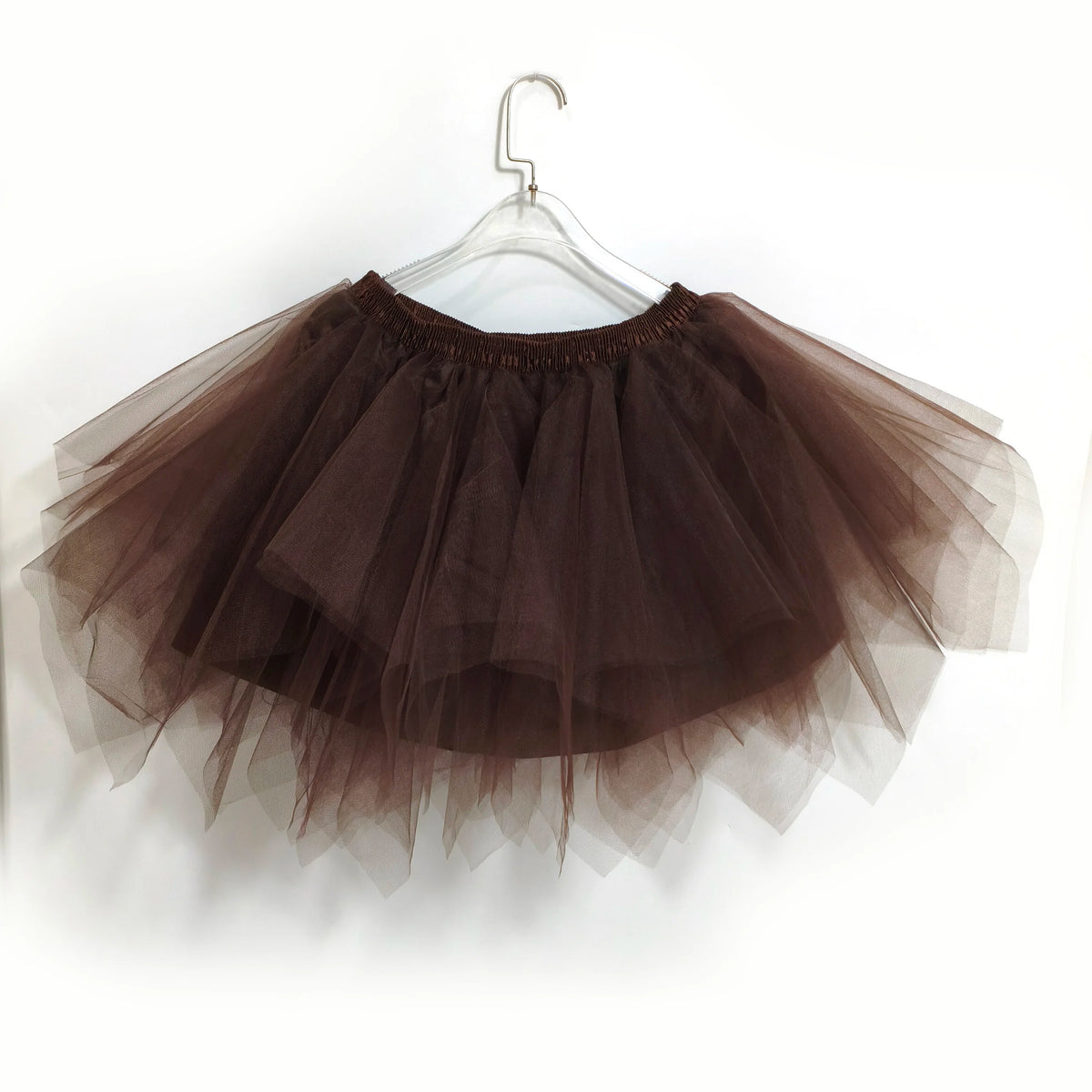 A sheer brown tulle tutu skirt displayed on a hanger.